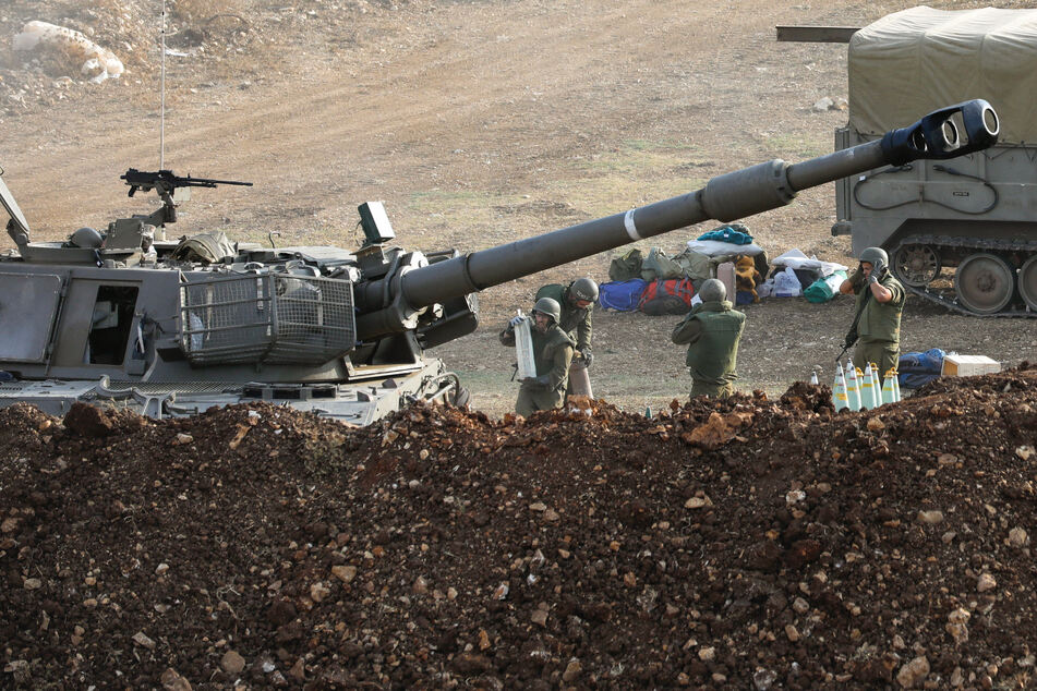Israeli forces launch artillery fire towards southern Lebanon from the border zone in northern Israel on October 9, 2023.