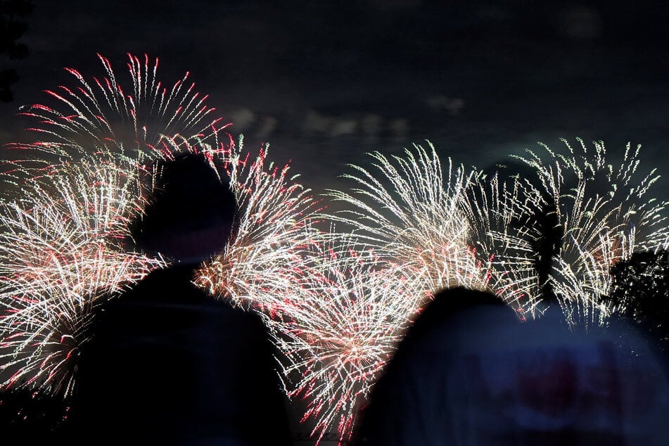 People watch fireworks explode during the Freedom 250's Salute to America in Washington DC in the early hours of July 5, 2026.