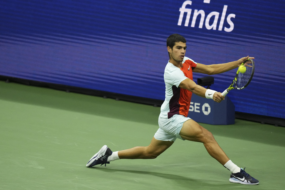 Carlos Alcaraz hits a backhand against Casper Ruud of Norway in the men's singles final on day fourteen of the 2022 US Open.