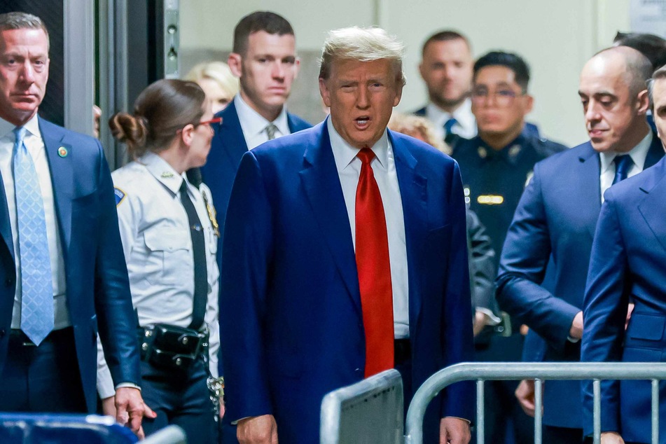 Donald Trump outside the New York courtroom during his hearing last month to determine the start date of his criminal trial for allegedly covering up hush money payments linked to Stormy Daniels.