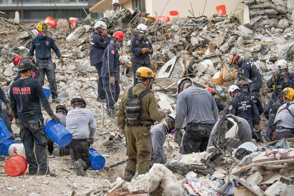 Members of the Israeli Defense Forces (IDF) Home Front Command on the scene of the building collapse in Surfside on Wednesday, hours before rescue operations were halted.