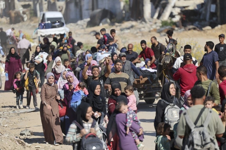 Forcibly displaced Palestinians flee Israeli military attacks in Beit Lahia in the northern Gaza Strip on October 22, 2024.