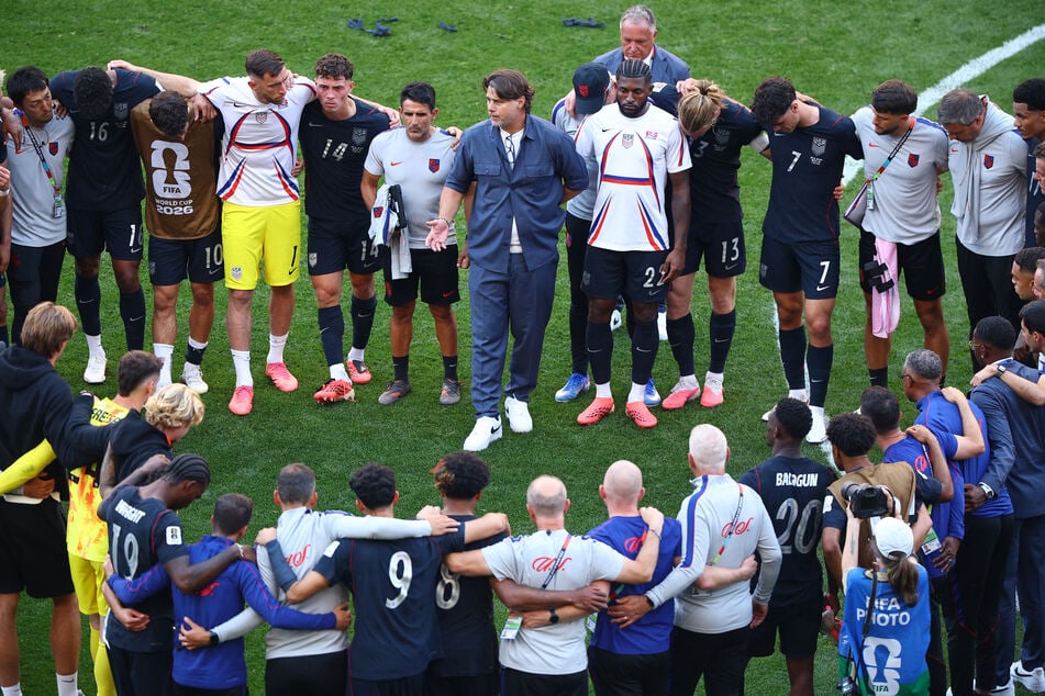 Coach Mauricio Pochettino speaks to the team after the match as the US are eliminated from the World Cup.