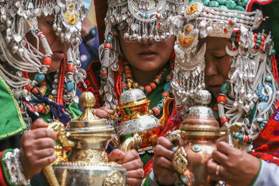 People dressed in traditional attire attend Tibetan spiritual leader the Dalai Lama’s prayer ceremony celebrating his 90th birthday at the Main Tibetan Temple in McLeod Ganj, near Dharamsala, on Sunday.