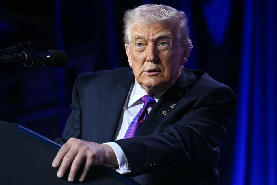 President Donald Trump (pictured) shared a post with a racist video depicting Barack and Michelle Obama as monkeys, sparking outrage across the political aisle Friday before deleting it in a rare backtrack.