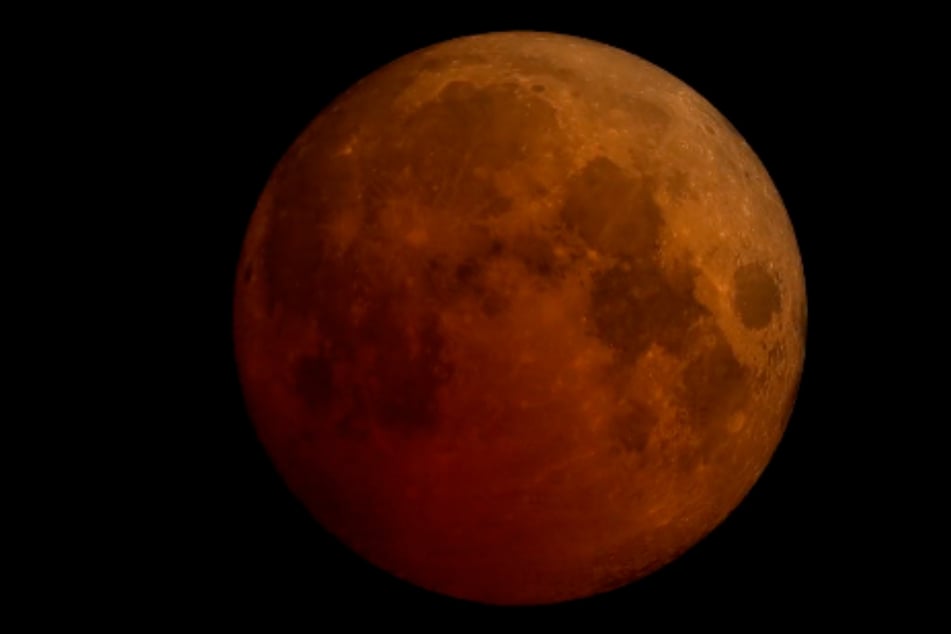 During a total lunar eclipse, the entire Moon gets blanketed by the Earth's shadow. This gives it a striking red hue, and its other name "Blood Moon."