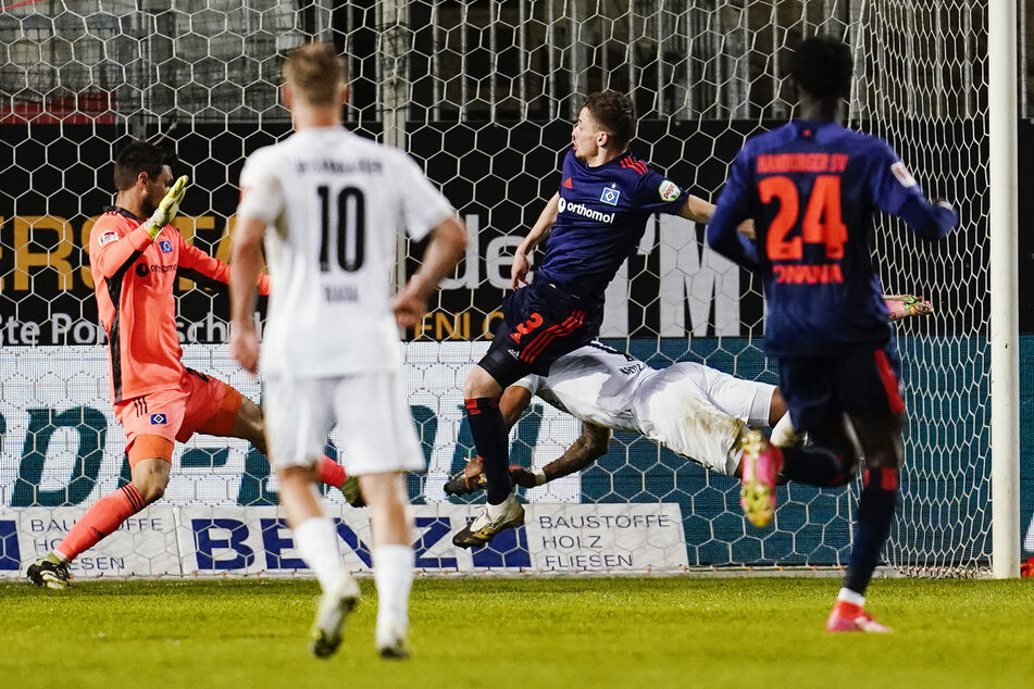 Sandhausens Daniel Keita Ruel (31, r.) erzielt an Hamburgs Moritz Heyer (26, M.) und Hamburgs Torwart Sven Ulreich (32) vorbei das Tor zum 2:0.