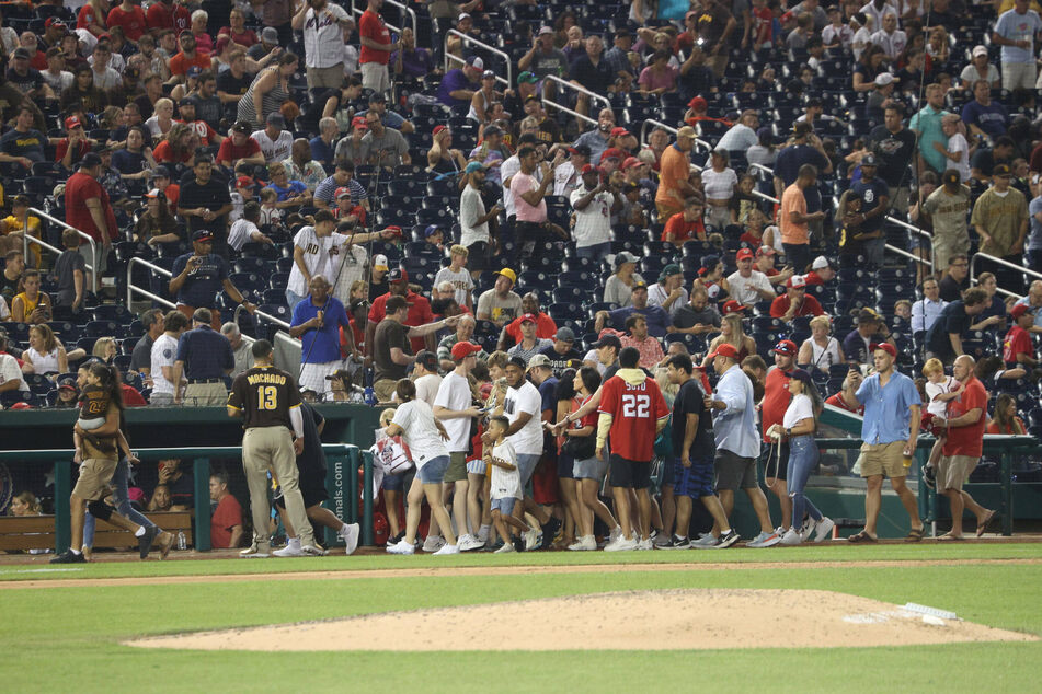 Fans were seen seeking shelter in the Padres' dugout after gunshots were heard outside Nationals Park on Saturday night