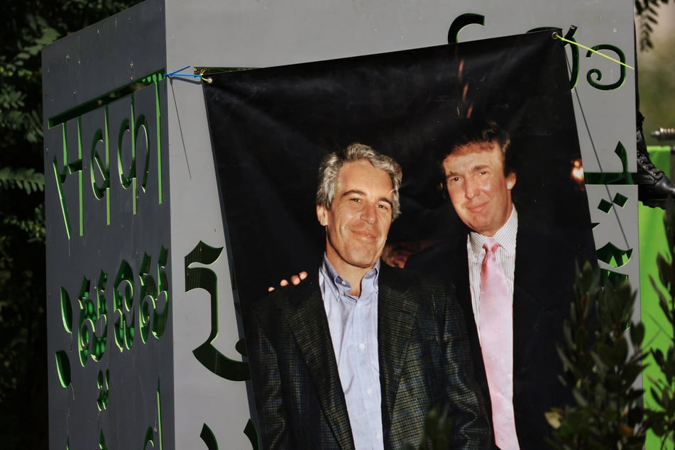 A banner of Jeffrey Epstein and President Donald Trump hangs in Grand Park during a protest against federal immigration raids in downtown Los Angeles, California, on August 2, 2025.
