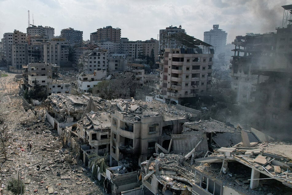 Smoke rises from houses and buildings destroyed by Israeli strikes in Gaza City on October 10, 2023.