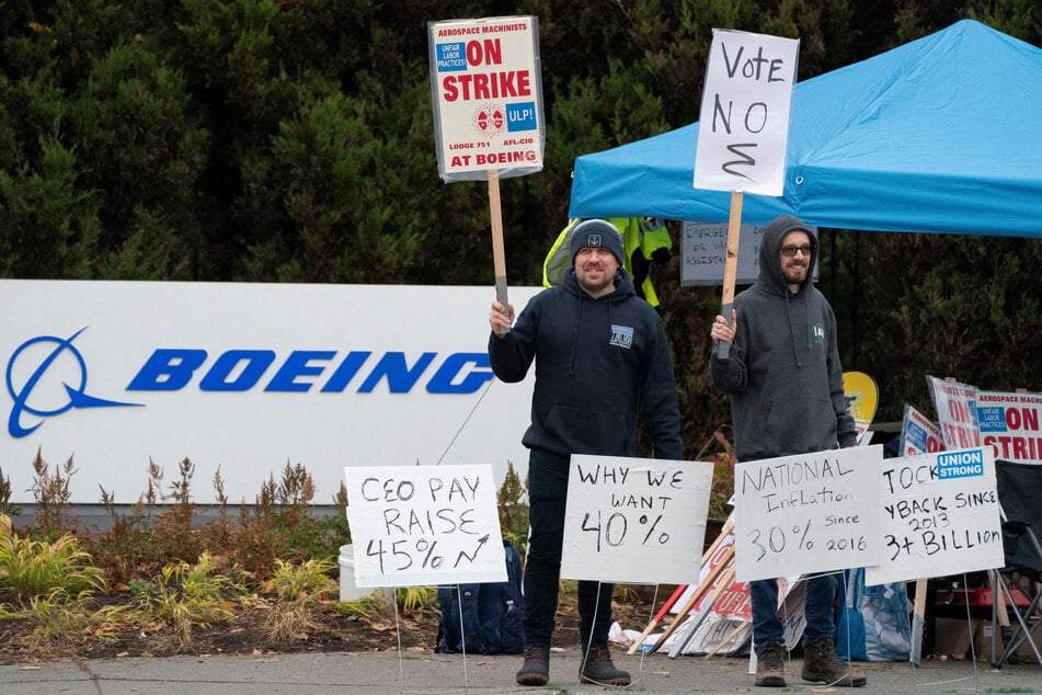 Boeing workers from the International Association of Machinists and Aerospace Workers District 751 gather on a picket line near the entrance to a production facility in Renton, Washington.