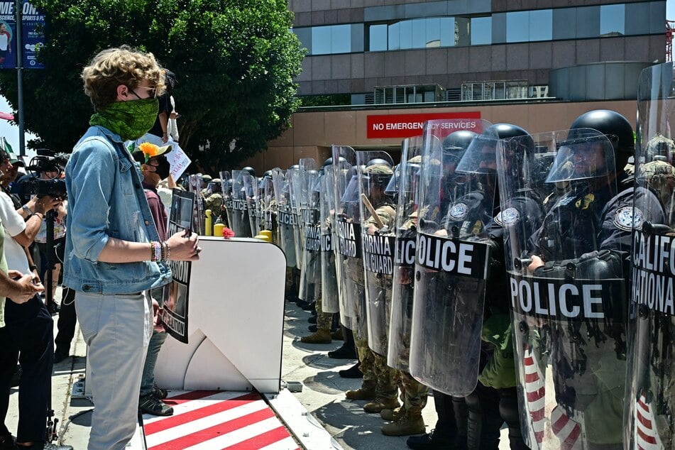 Protesters face members of the California National Guard and US Customs and Border Protection agents holding up shields outside the Federal Building in Los Angeles, on June 10, 2025.