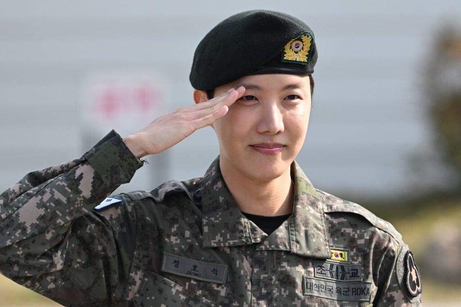 BTS member J-hope salutes after being discharged from his mandatory military service outside a base in Wonju, South Korea, on October 17, 2024.