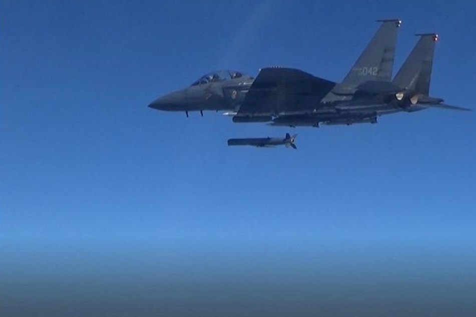 A South Korean Air Force F-15K fires an air-to-surface missile towards north of its maritime border with North Korea.