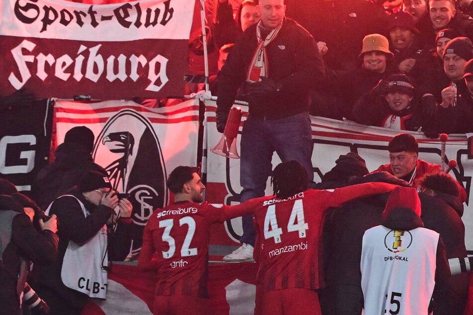 Die Freiburger feiern das Führungstor in der Verlängerung mit ihren Fans.