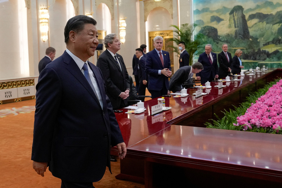 Chinese President Xi Jinping arrives at a bilateral meeting with US Senate Majority Leader Chuck Schumer and his delegation at the Great Hall of the People in Beijing on October 9, 2023.