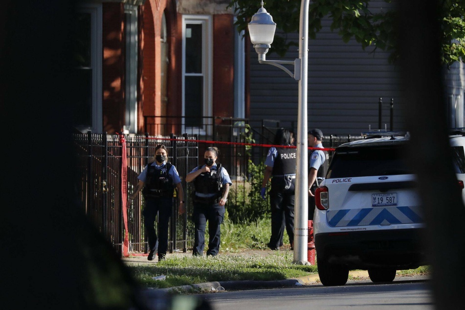 Police work at the scene of a mass shooting in Chicago's Englewood neighborhood.