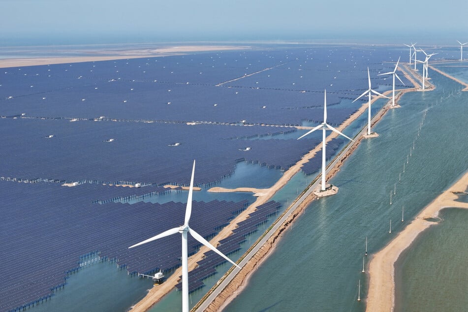 Solar panels and wind turbines are pictured at the Huaneng Binzhou new energy power generation project in Binzhou, in China’s eastern Shandong province.
