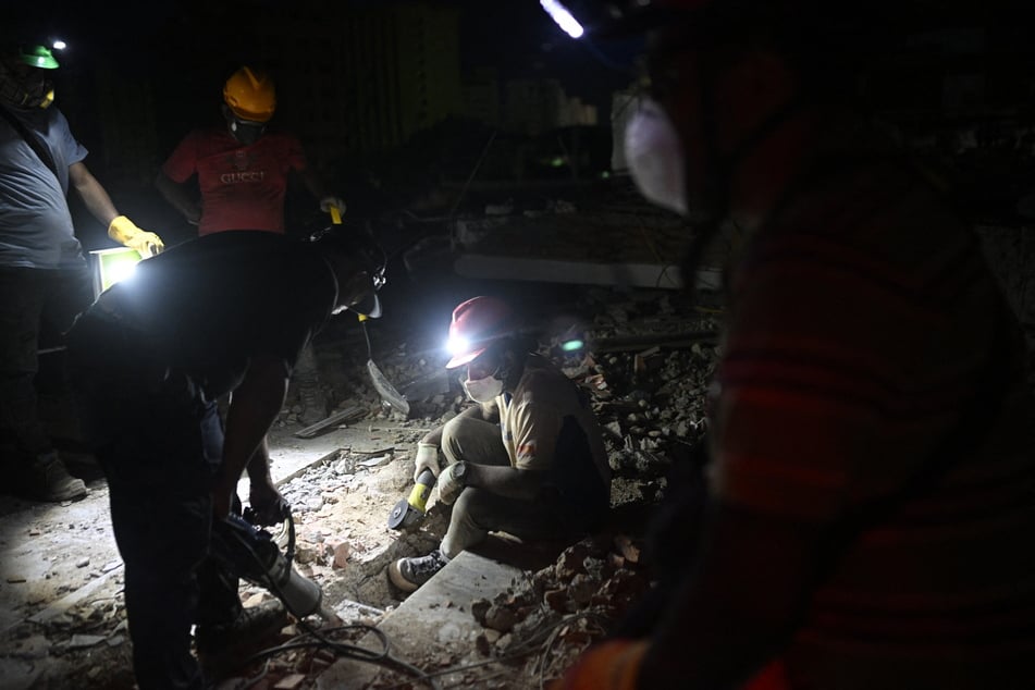 Workers clear debris at the site of a collapsed building in Catia La Mar, La Guaira State, Venezuela, on July 1, 2026, following the June 24 twin earthquakes.
