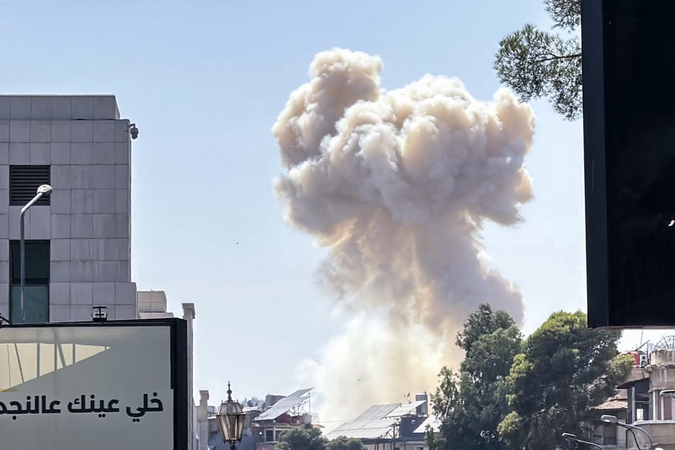 Smoke billows following Israeli strikes near the Syrian army and defense ministry headquarters in Damascus on July 16, 2025.