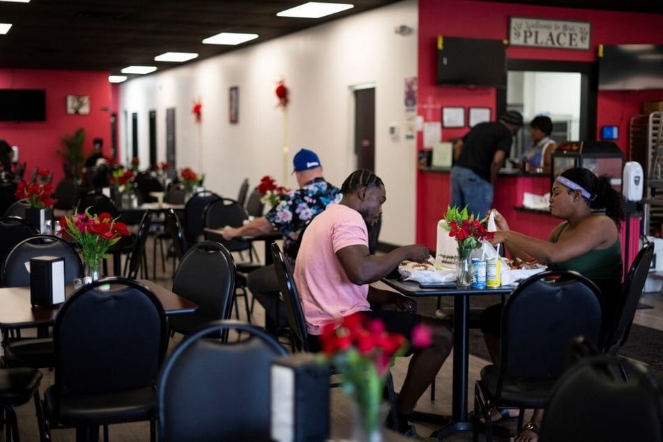 Residents sit down to eat a meal at a Haitian restaurant in Springfield, Ohio, on September 12, 2024.