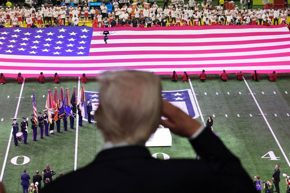 President Donald Trump salutes during the national anthem at the Super Bowl in New Orleans, Louisiana.