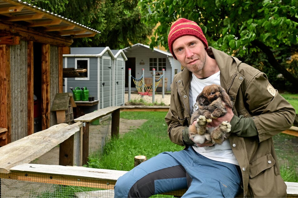 Erzieher Nico Finster (39) mit dem Hasen Elvis, der von den Kindern der Tagesstätte versorgt wird.