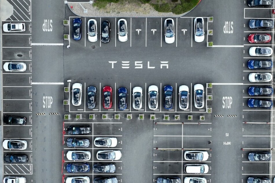 Tesla cars sit parked in a lot at the Tesla factory in Fremont, California.