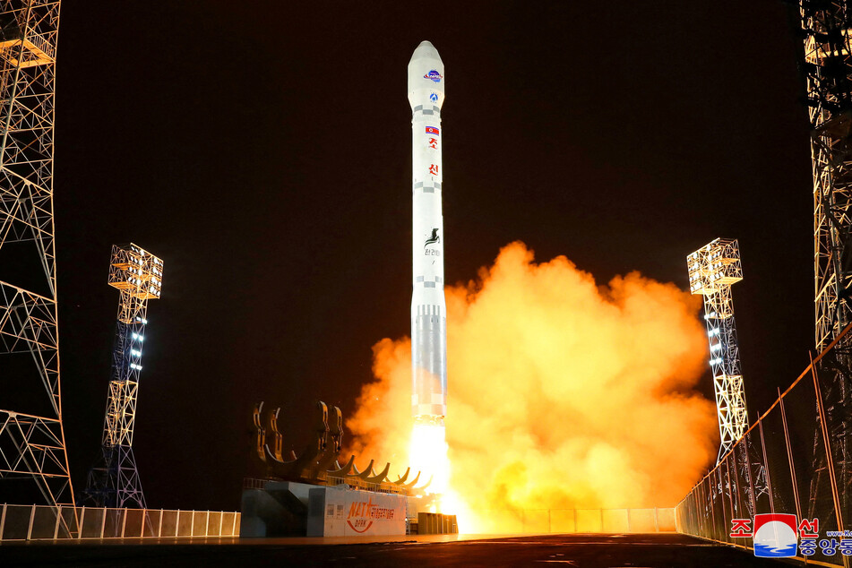 North Korea launched a military spy satellite into space at the third attempt, defying UN sanctions.