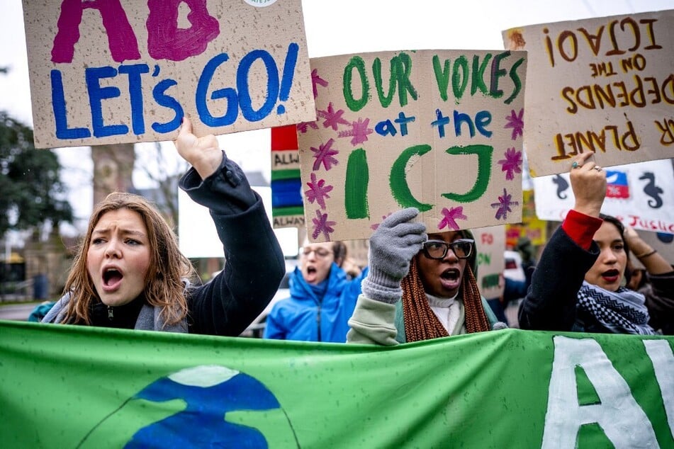 Activists demonstrate for climate justice in front of the International Court of Justice in The Hague, Netherlands.