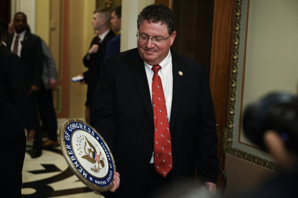 Representative Randy Fine holds a seal of the House after he is sworn in by Speaker Mike Johnson at the US Capitol on April 2, 2025.