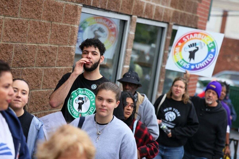 Starbucks workers hold a rally outside a Staten Island store calling for the right to negotiate employment terms.