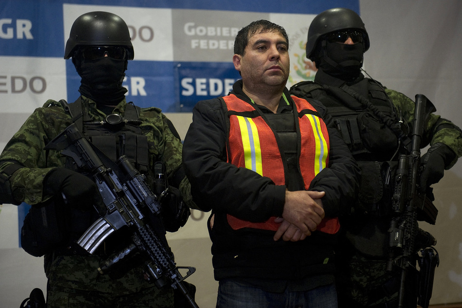 Members of the Mexican army escort alleged Sinaloa cartel member Felipe Cabrera Sarabia, who was sentenced to 19 years in prison after being extradited to the US.