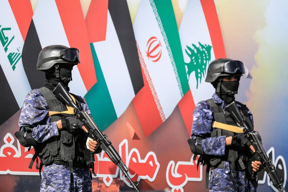 Security personnel stand guard during a rally by supporters of the Houthi movement in solidarity with Iran and Lebanon amid the US-Israeli war, in Sanaa, Yemen, on April 3, 2026.