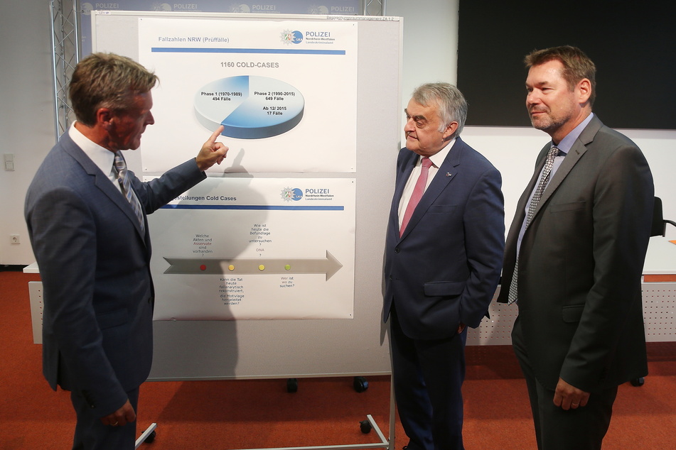 Andreas Müller (l-r), Leiter Operative Fallanalyse, LKA, erklärt Innenminister Herbert Reul (68, CDU) eine Infotafel mit "Cold-Case" Statistik. Rechts im Bild Ingo Wünsch, Direktor Landeskriminalamt Nordrhein-Westfalen.