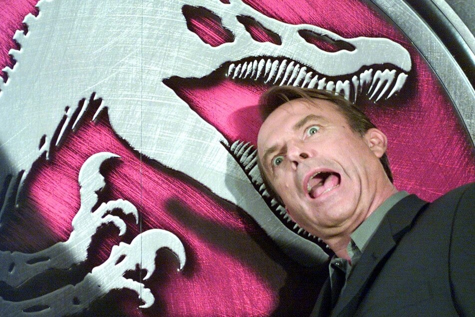 Sam Neill jokes during a press conference for the film Jurassic Park III at a hotel in Tokyo, Japan, on July 26, 2001.
