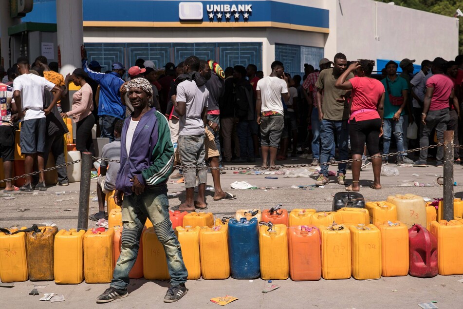 People crowd to get gasoline at a station in Port-au-Prince.