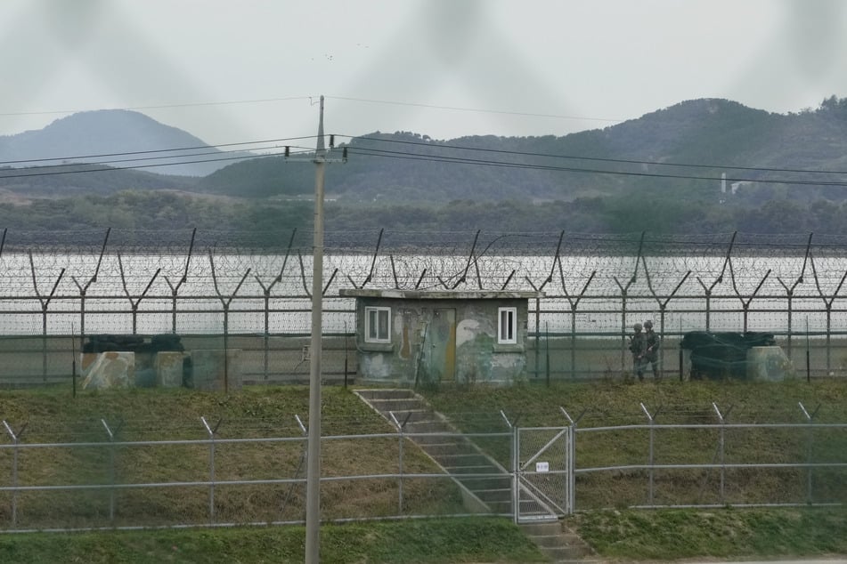 South Korean army soldiers patrol along the barbed wire fence in Paju, South Korea, near the border with North Korea.