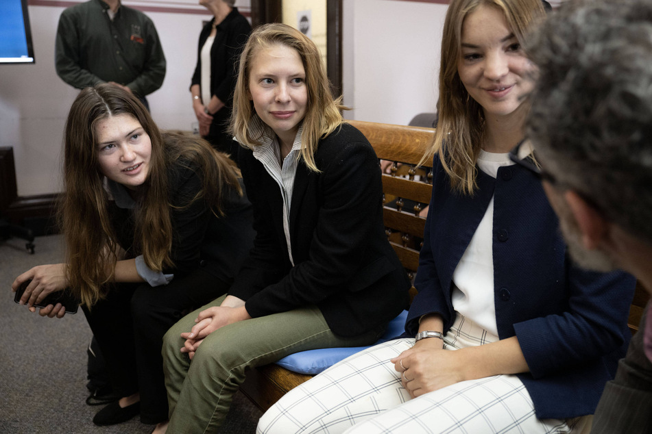 Plaintiffs in the landmark Held v. Montana climate change lawsuit sit together in the Lewis and Clark County Courthouse in Helena on the second day of their trial.