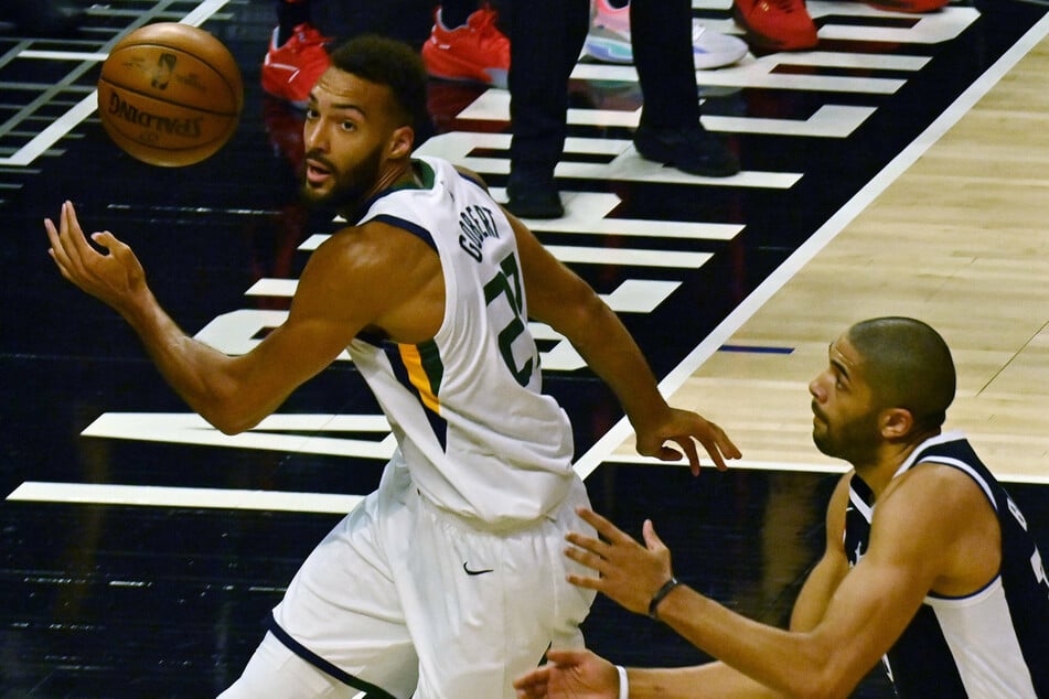 The reigning Defensive Player of the Year, Rudy Gobert (l.) and the Jazz look to continue their domination at the top of the league's regular-season standings.