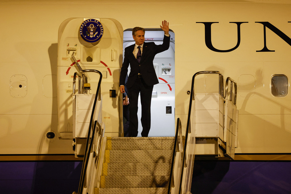 US Secretary of State Antony Blinken waves as he disembarks at the Brasilia Air Force Base in Brazil on February 20, 2024.