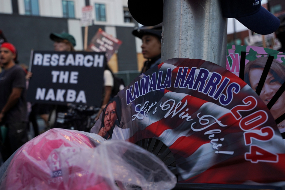 Gaza solidarity demonstrators raise a sign reading "Research the Nakba" on the sidelines of the Democratic National Convention in Chicago, Illinois