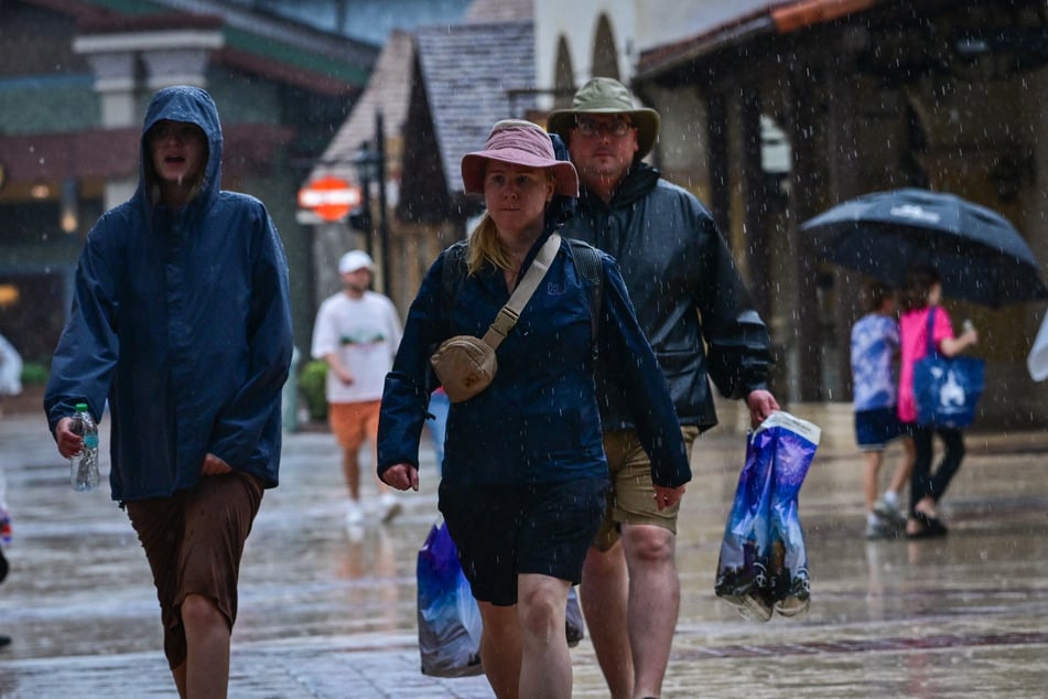 Visitors walk through the Disney Springs shopping center in Orlando ahead of Hurricane Milton's landfall in Florida on Wednesday.