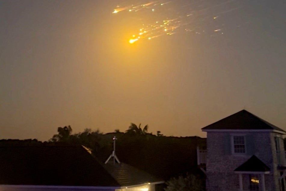 Debris streaks through the sky over Big Sampson Kay, Bahamas, on March 6, 2025, after SpaceX's Starship spacecraft tumbled and exploded in space.