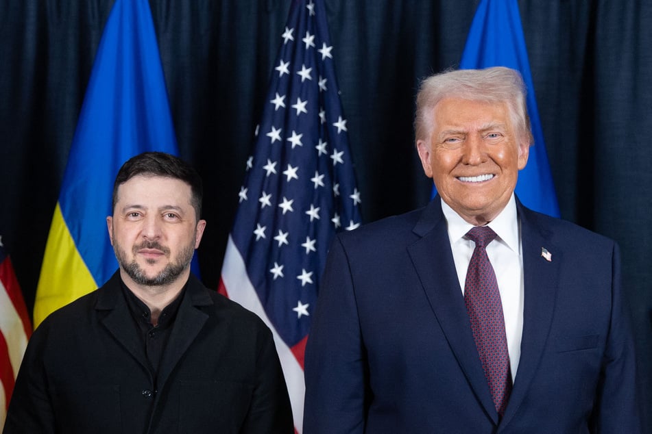 In this handout photograph taken and released by the Ukrainian Presidential Press Service on Thursday, Ukraine's President Volodymyr Zelensky (L) and US President Donald Trump pose for a photo during their meeting on the sidelines of the World Economic Forum (WEF) annual meeting in Davos.