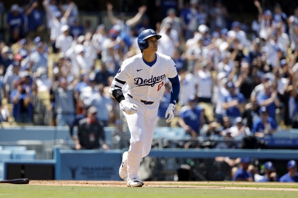 Shohei Ohtani of the Los Angeles Dodgers hits a two-run home run against pitcher Adrian Houser of the New York Mets during the third inning for his 176th career home run at Dodger Stadium on April 21, 2024.
