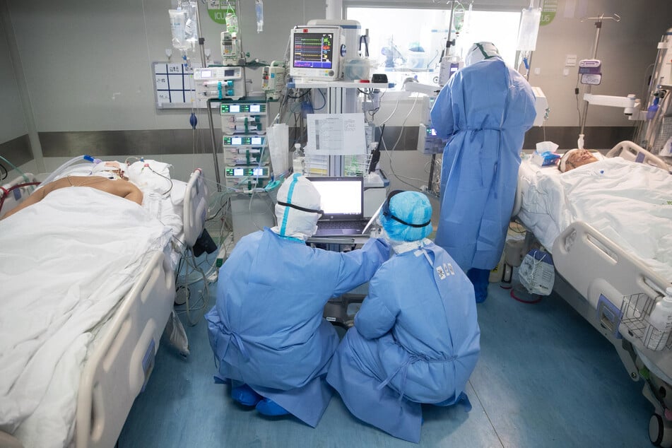 Medical staff treat COVID-19 coronavirus patients at a hospital in Wuhan, in China's central Hubei province on March 19, 2020.