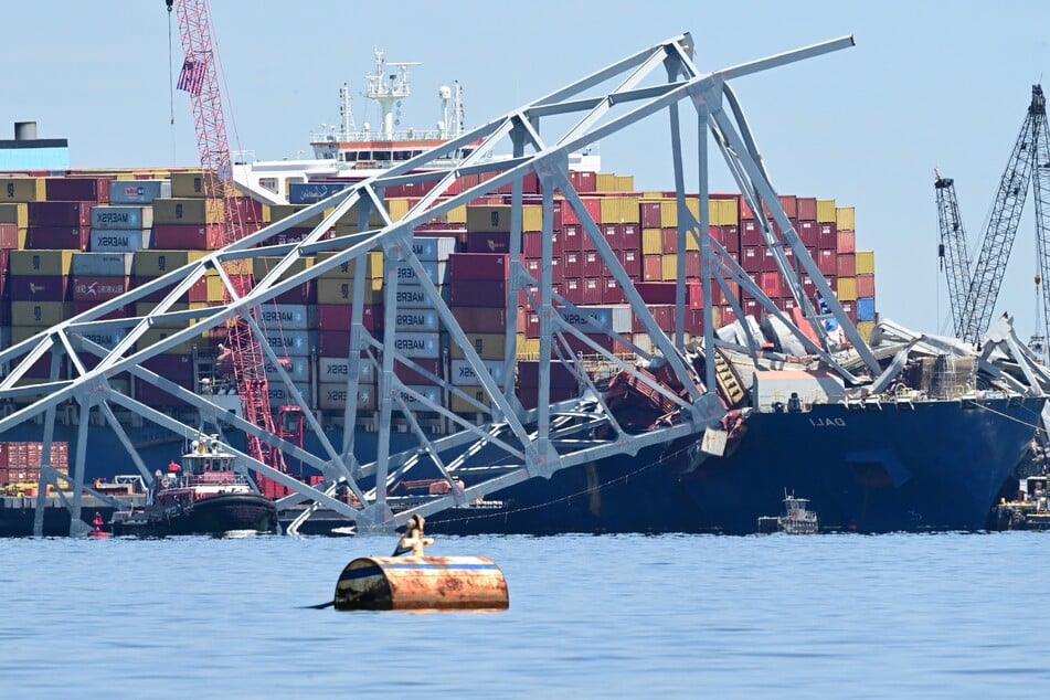 Workers continue to clear the wreckage of the Francis Scott Key Bridge and the container ship Dali in Baltimore, Maryland, on April 26, 2024. The first cargo ship passed through a temporary channel in Baltimore on April 25, after being trapped in the harbor since the bridge collapsed on March 26, 2024, halting most maritime traffic through the city’s port.