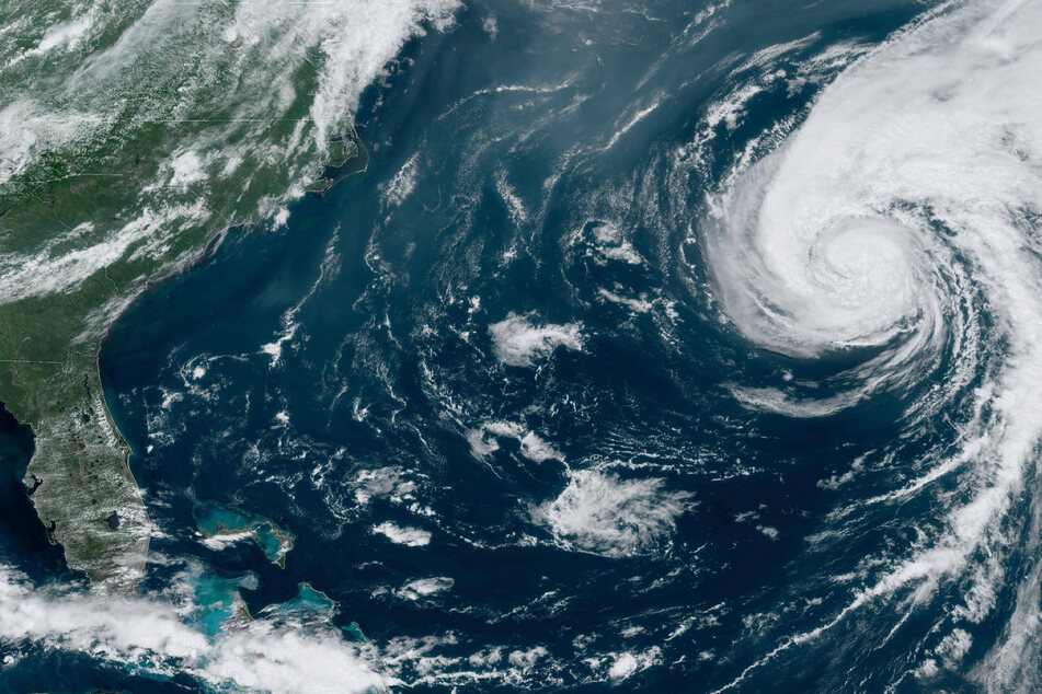 Hurricane Ernesto was downgraded to a tropical storm after it lashed Bermuda with heavy rains and strong winds before continuing toward eastern Canada.