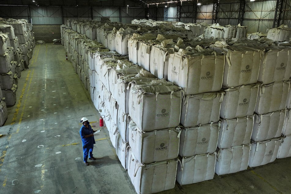 A worker checks super sacks with coffee beans at a farmers' cooperative warehouse in Franca, Brazil, on August 1, 2025.